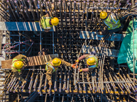 Workers are speeding up the construction of Taoyuan Bridge on the Beijing-Hangzhou Grand Canal in Suqian, East China's Jiangsu province, on...