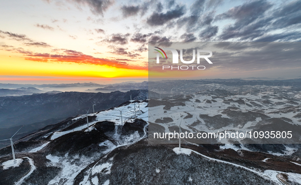 An aerial photo is showing a wind farm operating steadily on a barren mountain in Yichang, China, on January 24, 2024. 