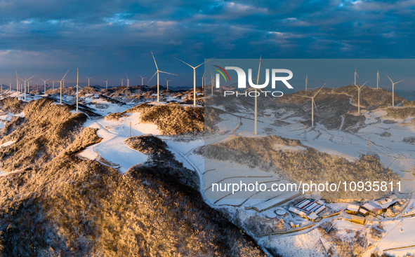 An aerial photo is showing a wind farm operating steadily on a barren mountain in Yichang, China, on January 24, 2024. 