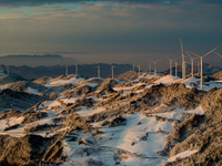 An aerial photo is showing a wind farm operating steadily on a barren mountain in Yichang, China, on January 24, 2024. (