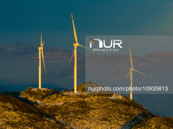 An aerial photo is showing a wind farm operating steadily on a barren mountain in Yichang, China, on January 24, 2024. 