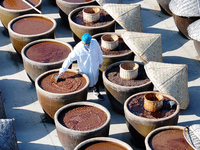 A worker at a soy sauce factory is checking the drying of sauces in a drying field in Lianyungang, China, on January 24, 2024. (