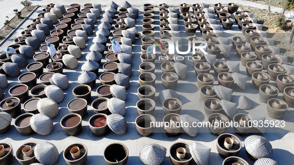 Workers are checking the drying of sauces in a drying field at a soy sauce factory in Lianyungang, Jiangsu Province, China, on January 24, 2...