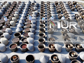 Workers are checking the drying of sauces in a drying field at a soy sauce factory in Lianyungang, Jiangsu Province, China, on January 24, 2...