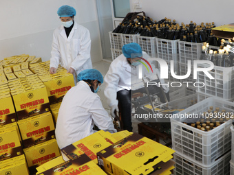 A worker is packing sauces at a soy sauce factory in Lianyungang, China, on January 24, 2024. (