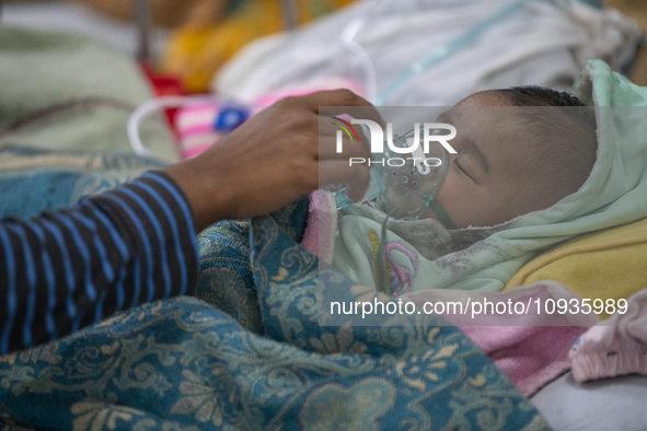 Abdul Ahad, who is three months old, is receiving medical treatment for pneumonia at Dhaka Shishu Hospital in Dhaka, Bangladesh, on January...