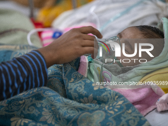 Abdul Ahad, who is three months old, is receiving medical treatment for pneumonia at Dhaka Shishu Hospital in Dhaka, Bangladesh, on January...