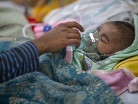 Abdul Ahad, who is three months old, is receiving medical treatment for pneumonia at Dhaka Shishu Hospital in Dhaka, Bangladesh, on January...