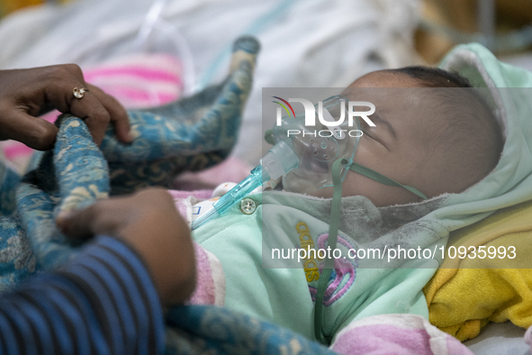 Abdul Ahad, who is three months old, is receiving medical treatment for pneumonia at Dhaka Shishu Hospital in Dhaka, Bangladesh, on January...