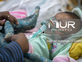 Abdul Ahad, who is three months old, is receiving medical treatment for pneumonia at Dhaka Shishu Hospital in Dhaka, Bangladesh, on January...