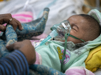 Abdul Ahad, who is three months old, is receiving medical treatment for pneumonia at Dhaka Shishu Hospital in Dhaka, Bangladesh, on January...