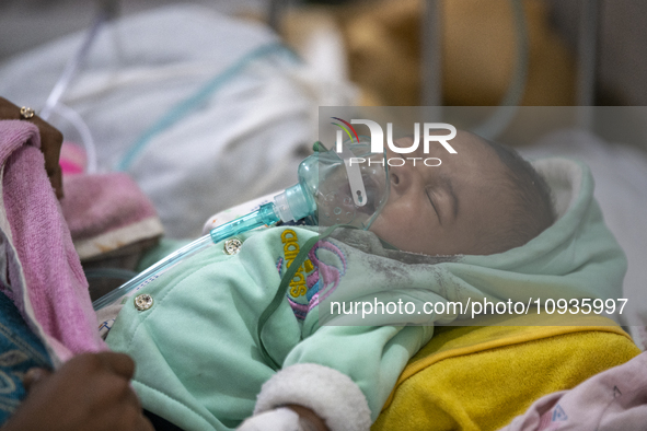 Abdul Ahad, who is three months old, is receiving medical treatment for pneumonia at Dhaka Shishu Hospital in Dhaka, Bangladesh, on January...