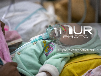 Abdul Ahad, who is three months old, is receiving medical treatment for pneumonia at Dhaka Shishu Hospital in Dhaka, Bangladesh, on January...