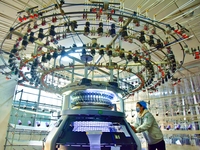 A worker is producing garment fabric at a weaving factory in Nantong, Jiangsu Province, China, on January 24, 2024. (