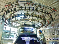 A worker is producing garment fabric at a weaving factory in Nantong, Jiangsu Province, China, on January 24, 2024. (