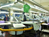 A worker is inspecting products at an automated knitwear assembly line in Nantong, Jiangsu province, China, on January 24, 2024. (