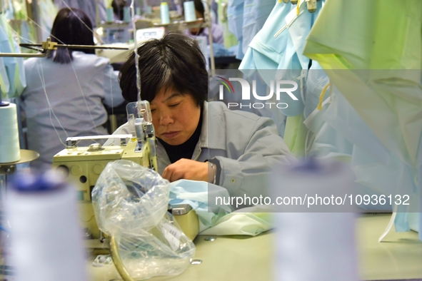 A worker is making sun-protective clothing products in Nantong, Jiangsu Province, China, on January 24, 2024. 