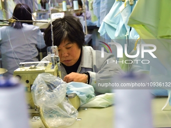 A worker is making sun-protective clothing products in Nantong, Jiangsu Province, China, on January 24, 2024. (