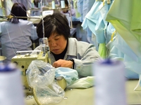 A worker is making sun-protective clothing products in Nantong, Jiangsu Province, China, on January 24, 2024. (