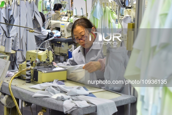 A worker is making sun-protective clothing products in Nantong, Jiangsu Province, China, on January 24, 2024. 