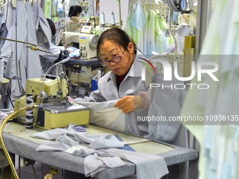 A worker is making sun-protective clothing products in Nantong, Jiangsu Province, China, on January 24, 2024. (