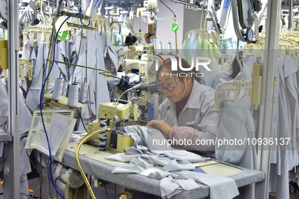 A worker is making sun-protective clothing products in Nantong, Jiangsu Province, China, on January 24, 2024. 