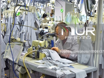 A worker is making sun-protective clothing products in Nantong, Jiangsu Province, China, on January 24, 2024. (