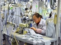 A worker is making sun-protective clothing products in Nantong, Jiangsu Province, China, on January 24, 2024. (