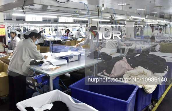 Workers are producing clothing products in Nantong, Jiangsu Province, China, on January 24, 2024. 