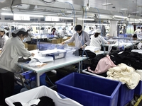 Workers are producing clothing products in Nantong, Jiangsu Province, China, on January 24, 2024. (