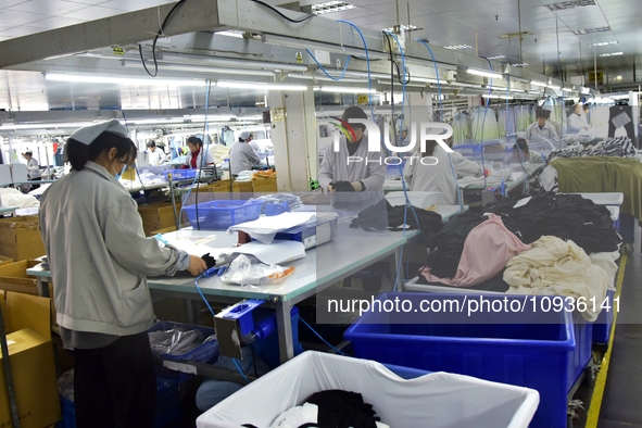 Workers are producing clothing products in Nantong, Jiangsu Province, China, on January 24, 2024. 