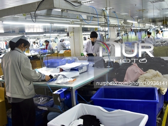 Workers are producing clothing products in Nantong, Jiangsu Province, China, on January 24, 2024. (