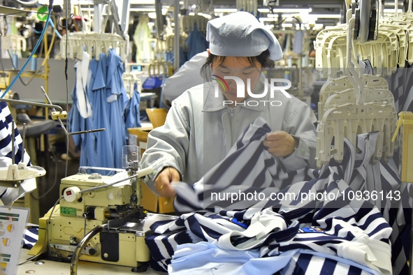 Workers are producing clothing products in Nantong, Jiangsu Province, China, on January 24, 2024. 