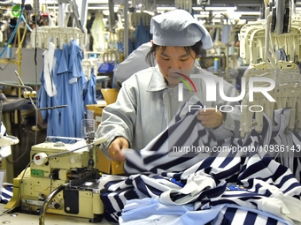 Workers are producing clothing products in Nantong, Jiangsu Province, China, on January 24, 2024. (