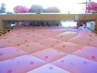 An employee is processing a cotton-padded quilt at a quilt processing shop in Anqing, China, on January 25, 2024. (