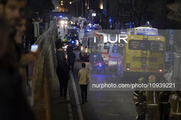 Ambulances and firefighters are at the site of the fire at the Gandhi Hotel Hospital in northern Tehran, on January 25, 2024. Patients are b...