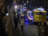 Ambulances and firefighters are at the site of the fire at the Gandhi Hotel Hospital in northern Tehran, on January 25, 2024. Patients are b...