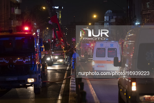 Ambulances and firefighters are at the site of the fire at the Gandhi Hotel Hospital in northern Tehran, on January 25, 2024. Patients are b...