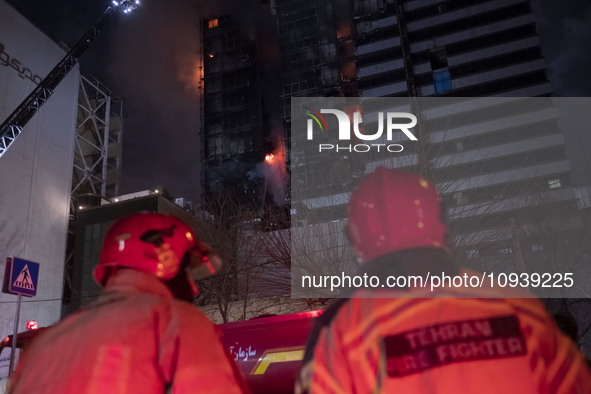 Firefighters are at the site of the fire at the Gandhi hotel hospital in northern Tehran, Iran, on January 25, 2024. They are safely evacuat...