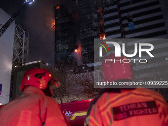 Firefighters are at the site of the fire at the Gandhi hotel hospital in northern Tehran, Iran, on January 25, 2024. They are safely evacuat...