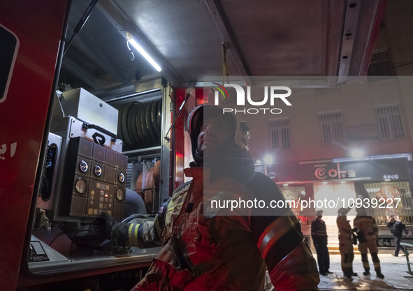 Firefighters are at the site of the fire at the Gandhi hotel hospital in northern Tehran, Iran, on January 25, 2024. They are safely evacuat...