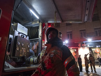 Firefighters are at the site of the fire at the Gandhi hotel hospital in northern Tehran, Iran, on January 25, 2024. They are safely evacuat...