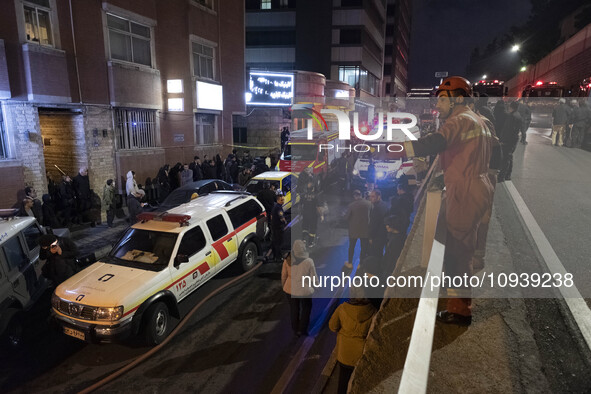 Ambulances and firefighters are at the site of the fire at the Gandhi Hotel Hospital in northern Tehran, on January 25, 2024. Patients are b...