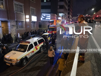 Ambulances and firefighters are at the site of the fire at the Gandhi Hotel Hospital in northern Tehran, on January 25, 2024. Patients are b...