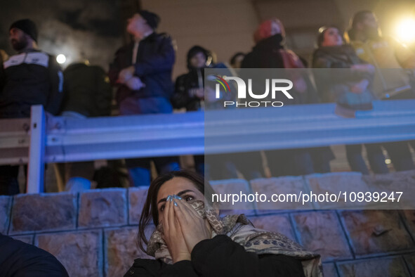 An Iranian woman is reacting while standing at the site of the fire at the Gandhi hotel hospital in northern Tehran, Iran, on January 25, 20...