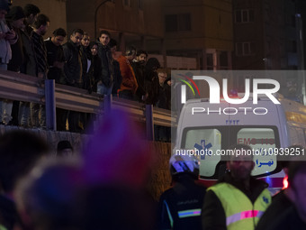 People are watching while standing at the site of the fire at the Gandhi hotel hospital in northern Tehran, Iran, on January 25, 2024. Patie...