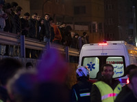 People are watching while standing at the site of the fire at the Gandhi hotel hospital in northern Tehran, Iran, on January 25, 2024. Patie...