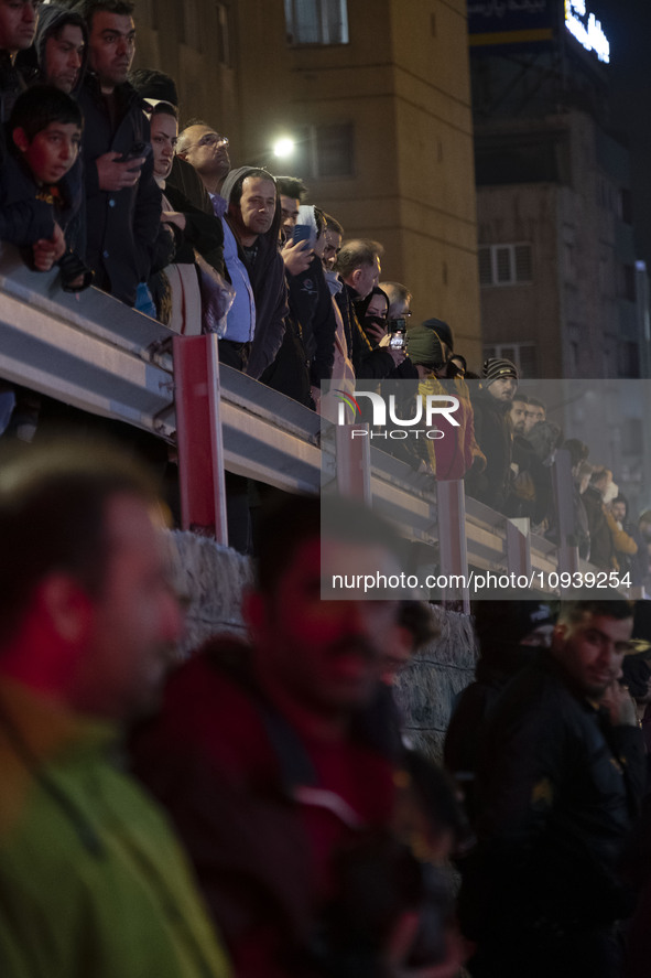 People are watching while standing at the site of the fire at the Gandhi hotel hospital in northern Tehran, Iran, on January 25, 2024. Patie...