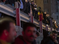 People are watching while standing at the site of the fire at the Gandhi hotel hospital in northern Tehran, Iran, on January 25, 2024. Patie...