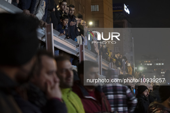 People are watching while standing at the site of the fire at the Gandhi hotel hospital in northern Tehran, Iran, on January 25, 2024. Patie...